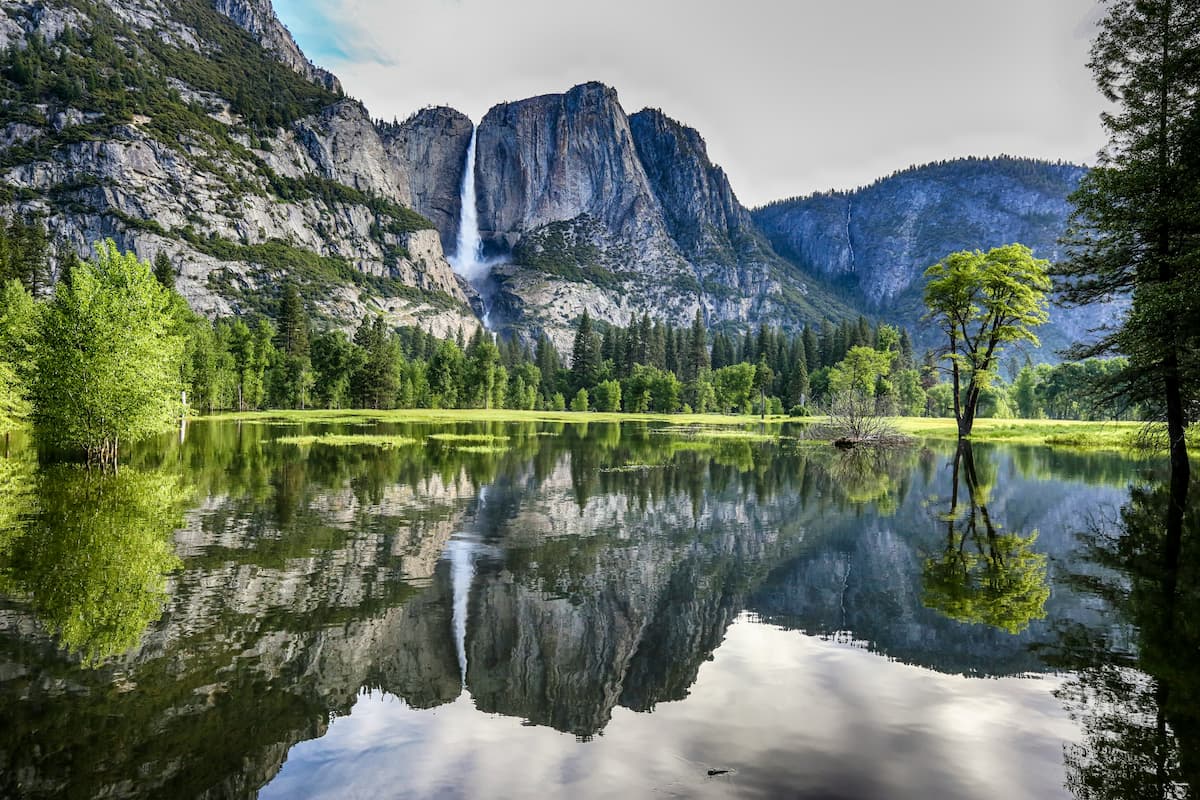 Iconic view of Yosemite Valley with Bridalveil Fall cascading down granite cliffs.